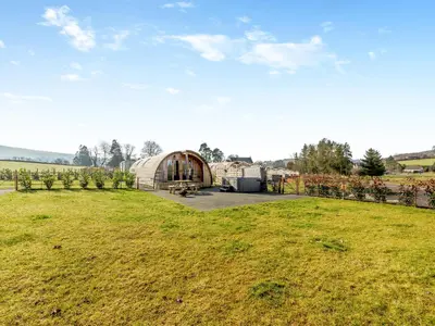 a large greenhouse in a field next to a field of grass at Primrose - Uk42358 in Saint Harmon