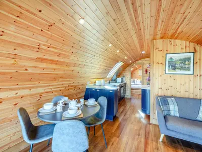a wooden room with a table and chairs and a kitchen at Primrose - Uk42358 in Saint Harmon