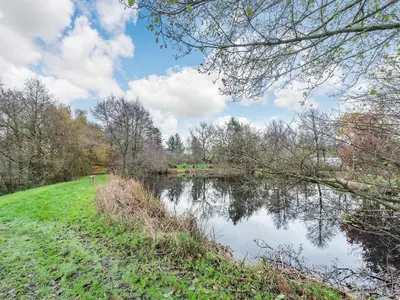 a view of a river with trees and a field at Snowdrop in Llanerch-Aeron