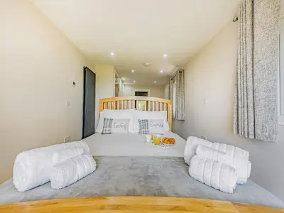 a bedroom with a large bed with white pillows at Llwynblyfyn in Llansawel