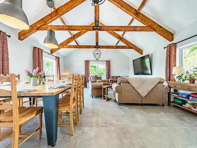 a dining room with a table and chairs at Llwynblyfyn in Llansawel