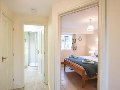 a bedroom with a bed and a mirror at The Corn House - Cottage in Great Hanwood