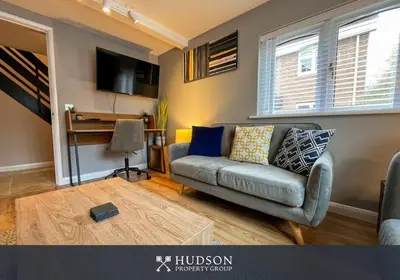 a living room with a couch and a table at 2 Bedroom Home near Theatre Severn with Parking in Shrewsbury