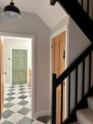 a hallway with a green door and a checkered floor at Charming Townhouse Retreat in Shrewsbury