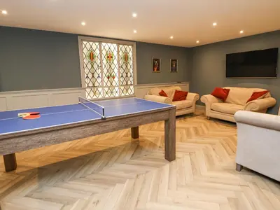 a living room with a ping pong table at Tanat House in Oswestry