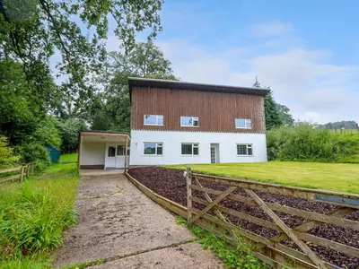 a large white building with a barn at The Wardens House in Newtown