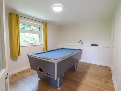 a pool table in a room with a window at The Wardens House in Newtown