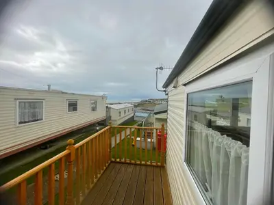 a balcony with a view of a house at Gorgeous Sea Viev 3 Bedroom Delta Bromley Deluxe in Aberystwyth