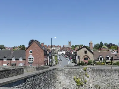 a view of a town with a stone wall at Troutbeck Cottage in Ludlow