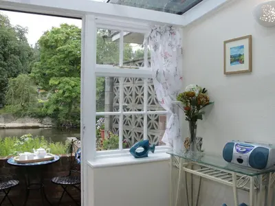 a room with a window with a view of a river at Troutbeck Cottage in Ludlow