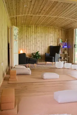 a living room with wood paneling and a room with chairs and tables at The Hornbill at Home Farm Shropshire in Shrewsbury