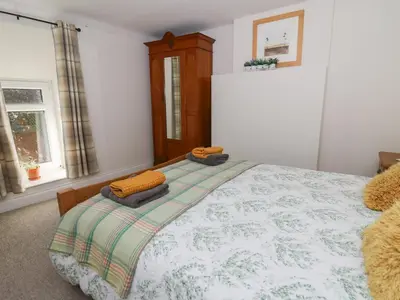 a bedroom with a bed with two pillows on it at Pengraig in Tregaron
