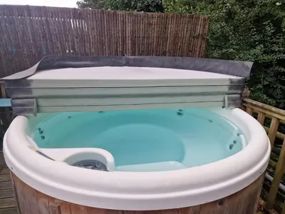 a jacuzzi tub sitting in a yard at Glan yr Afon Dau - Relax Recuperate Hot Tub in Welshpool