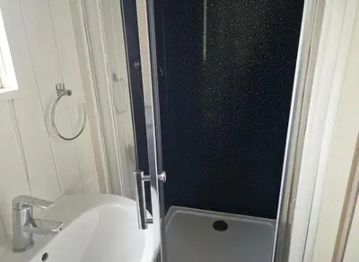 a bathroom with a toilet and a sink and a shower at Glan yr Afon Un - Relax Recuperate Enjoy in Welshpool