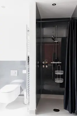 a bathroom with a shower with a toilet and a sink at Finest Retreats - The Welsh Barn in Aberystwyth