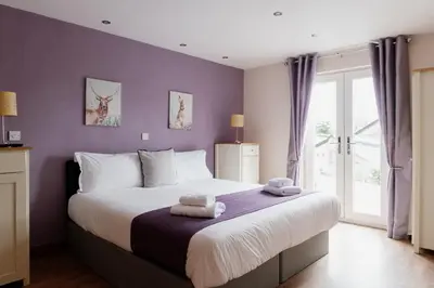 a bedroom with a large bed with towels on it at Finest Retreats - The Welsh Barn in Aberystwyth