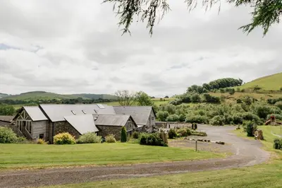 an image of a farm house with a driveway at Finest Retreats - The Welsh Barn in Aberystwyth