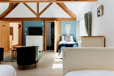 a bedroom with a bed and a living room at Finest Retreats - The Welsh Barn in Aberystwyth