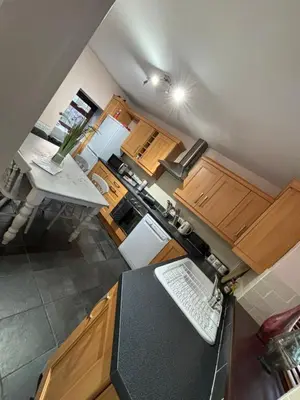 an overhead view of a kitchen with wooden cabinets at Glanyrafon Cottage in Sennybridge
