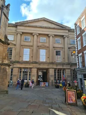 a large building with people standing outside of it at Cosy Corner - Town centre flat with free nearby parking in Shrewsbury