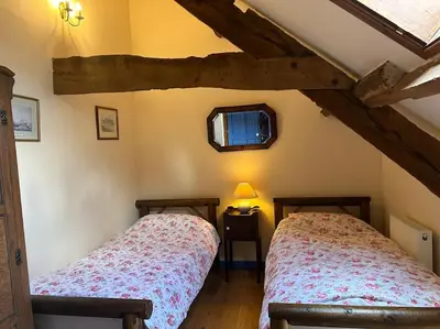 a bedroom with two twin beds in a attic at Happy Horse Cottages in Sennybridge