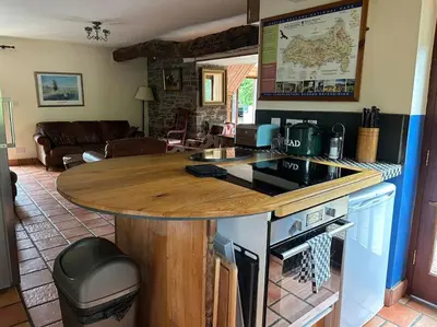 a kitchen with a wooden counter top in a living room at Happy Horse Cottages in Sennybridge