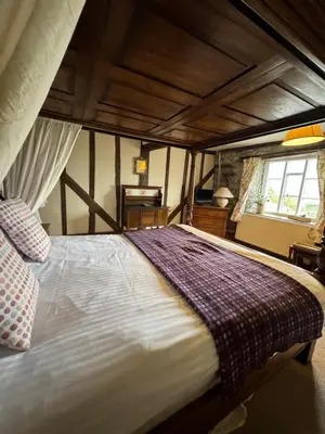 a bedroom with a large bed in a room at The Harp Inn in Old Radnor