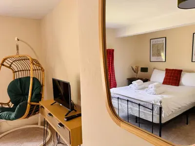 a bedroom with a bed and a mirror at The Harp Inn in Old Radnor