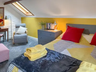 a bedroom with a large bed with a red pillow at The Hideaway in Tregaron
