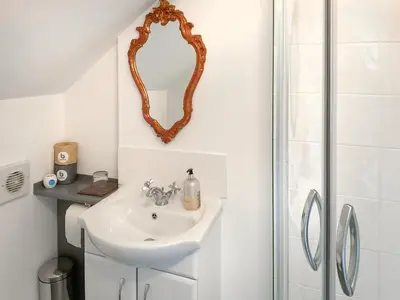 a bathroom with a sink and a mirror at The Hideaway in Tregaron