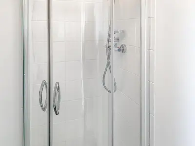 a bathroom with a shower with a glass door at The Hideaway in Tregaron