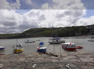 a group of boats sitting in the water at Newquay Haven caravan 42x14 with Ocean Views in New Quay