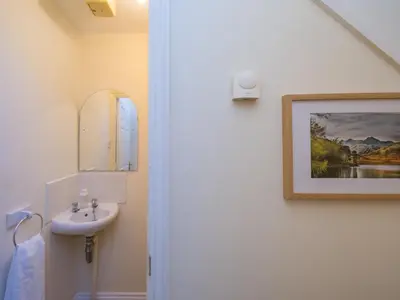 a bathroom with a sink and a picture on the wall at 3 bedroom detached homesleeps 5 in Shrewsbury - Pass the Keys in Bicton