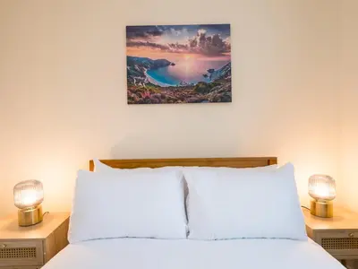 a bedroom with a bed and two night stands with lamps at 3 bedroom detached homesleeps 5 in Shrewsbury - Pass the Keys in Bicton