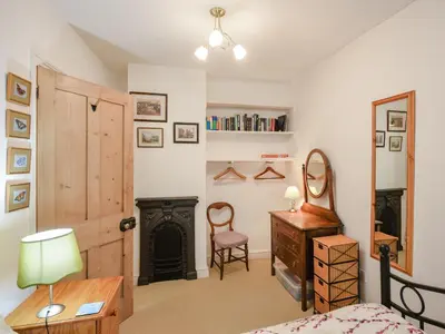 a bedroom with a bed and a desk and a chair at Paul Pry in Ludlow