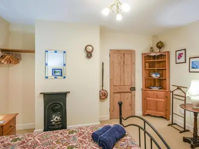 a bedroom with a fireplace and a bed in a room at Paul Pry in Ludlow