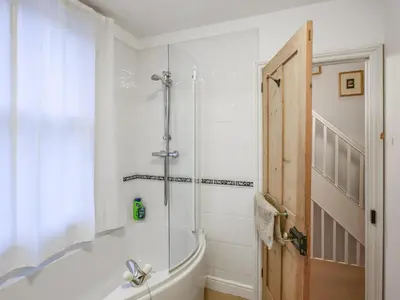 a white bathroom with a tub and a shower at Paul Pry in Ludlow