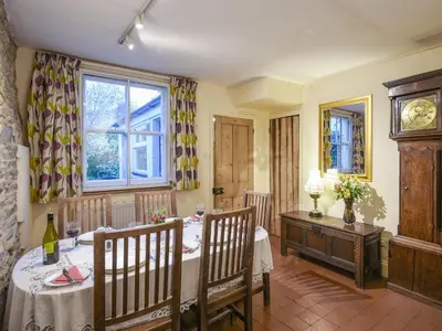 a dining room with a table and chairs and a window at Paul Pry in Ludlow