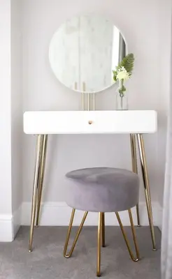 a dressing table with a chair and a mirror at Harbourside luxury house in Aberaeron