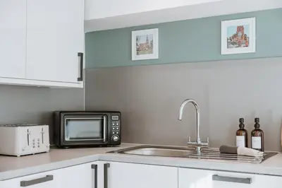 a kitchen with a sink and a microwave at 2 Bed Apartment Overlooking the Square Step Out to Shops & Dining in Shrewsbury