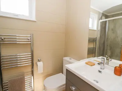 a bathroom with a toilet and a sink at Seren Lodge in Builth Wells