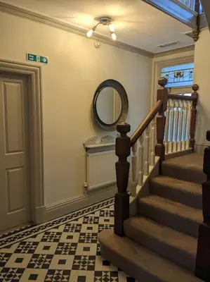 a hallway with a staircase with a mirror and a mirror at Cartref Guesthouse - Room 2 Ensuite in Aberdyfi