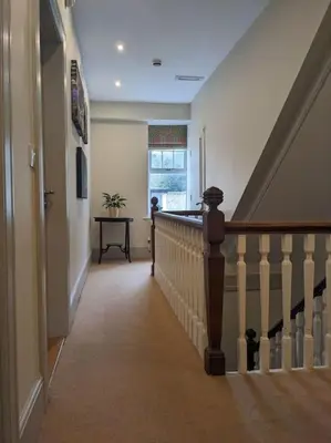 a hallway of a home with a staircase and a window at Cartref Guesthouse - Room 2 Ensuite in Aberdyfi