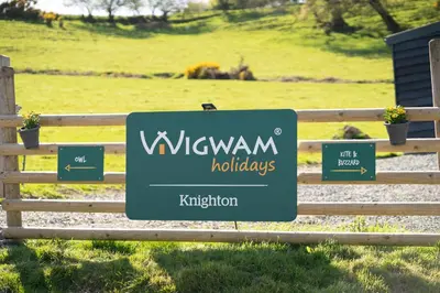 a sign for the w welwyn holidays on a fence at Knighton by Wigwam Holidays in Knighton