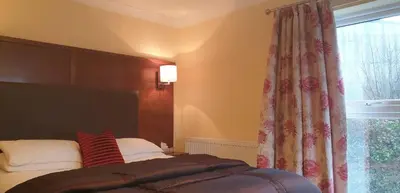a bedroom with a bed and a window at Usk And Railway Inn in Sennybridge