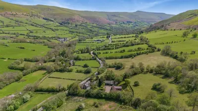 an aerial view of a valley with green fields and trees at 7 Bed in Talgarth oc-h30349 in Talgarth