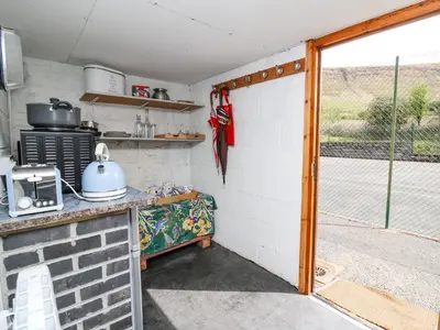 a kitchen with a door open to a patio at Ty Hir at Blaenbrynich Farm in Brecon