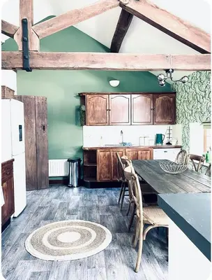 a kitchen with a table and chairs in a room at The Coach House in Berriew