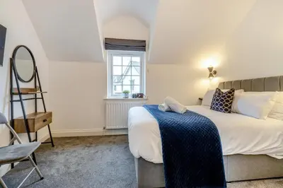 a bedroom with a bed and a chair and a window at 2 Bed in Capel Bangor oc-m30146 in Capel Bangor
