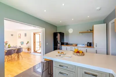 a kitchen with a white counter and a dining room at 5 Bed in Pant-y-Dwr oc-w30200 in Pant-y-dwr